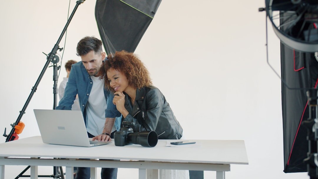 Two journalists reviewing content on screen collaboratively