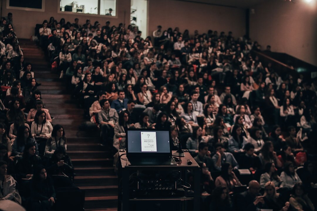 Large broadcast journalism conference with audience